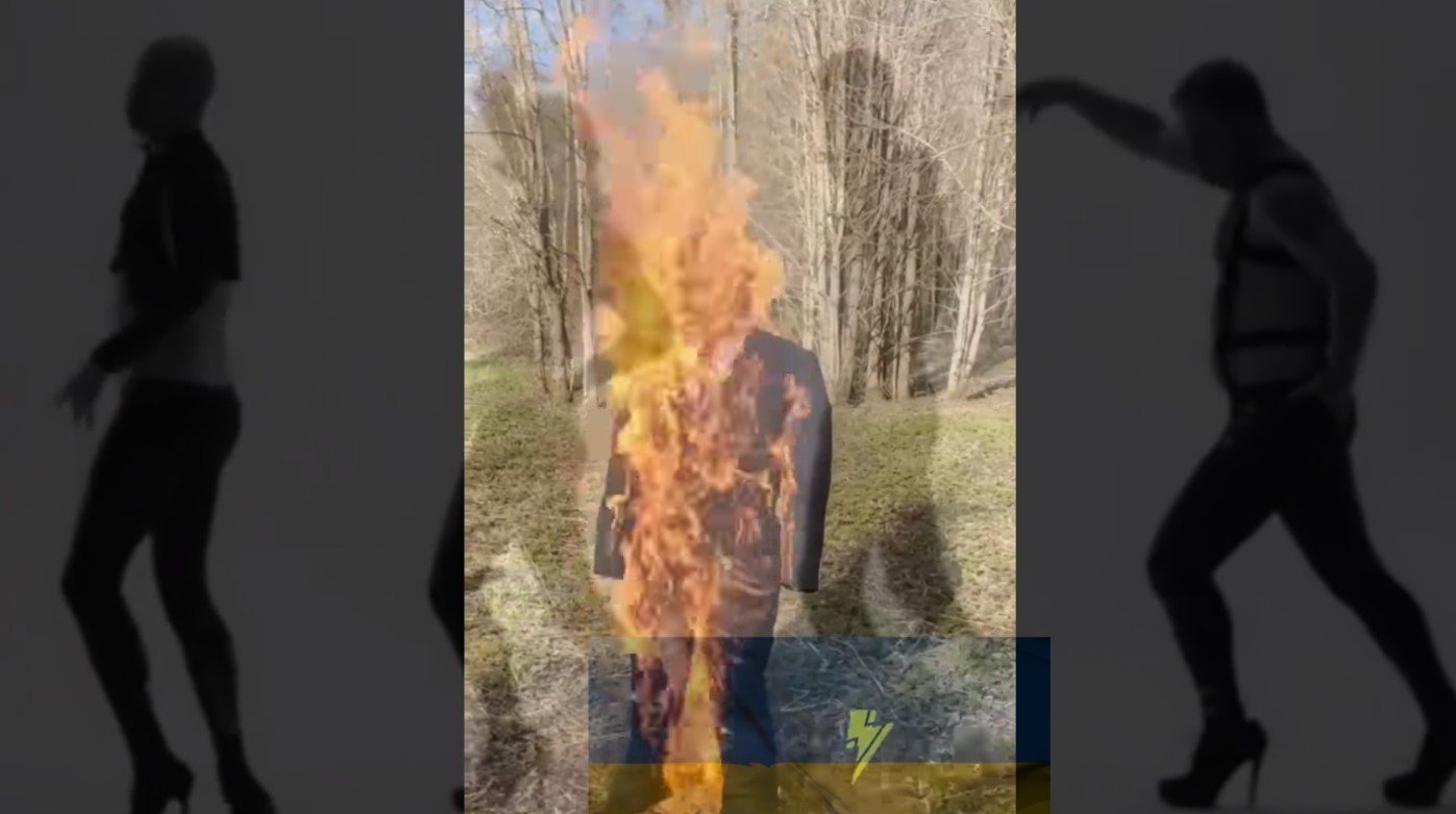 Masked Ukrainians burn a life-like Donald Trump dummy while personally addressing him.